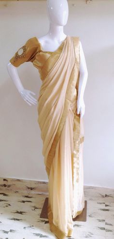 "The saree is classy, gorgeous and whats more, a true conversation starter. Soft beige gold semi jute saree with gold border and hand embroidered beads is paired with a stunning mirror work blouse. The design is of an embellished looking glass with a big mirror and gold zardosi work borders. Wear this, stand out and work your magic. Contact me for other colors! Saree fabric: semi jute Length 5.5 meters Blouse:1 meter 44\" wide Shipping: Ships in 1-2 days of payment with tracking number. Shipping Gold Chanderi Pre-draped Saree With Gota Work, Gold Pre-draped Dola Silk Saree With Dupatta, Festive Gold Pre-draped Saree With Mirror Work, Elegant Beige Saree With Unstitched Blouse, Festive Beige Blouse Piece With Traditional Drape, Gold Pre-draped Saree With Cutdana For Navratri, Traditional Gold Pre-draped Saree For Navratri, Elegant Tussar Silk Saree With Gota Work, Navratri Gold Chanderi Pre-draped Saree