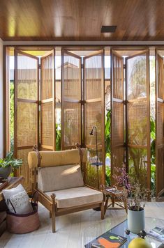 a living room filled with furniture and windows covered in bamboo blinds on top of them