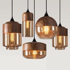 four lights hanging from the ceiling with different shades of light on them, one is brown and