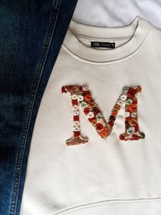 Embroidered sweatshirt. You can choose a word (5-6 letters) or a large letter in the middle. No returns or exchanges But please contact me if you have any problems with your order. Brown Embroidered Sweatshirt, Black Sweatshirt Embroidery Ideas, Word Embroidery On Clothes, Embroidery On Crew Neck, Custom Embroidered Long Sleeve T-shirt, White Hoodie With Embroidered Graphics For Fall, White T-shirt With Embroidered Text For Fall, White Hoodie With Custom Embroidery For Fall, White Cotton Sweater With Embroidered Graphics