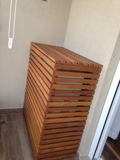 a wooden box sitting on top of a hard wood floor next to a white door