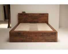 a bed made out of wood with no sheets