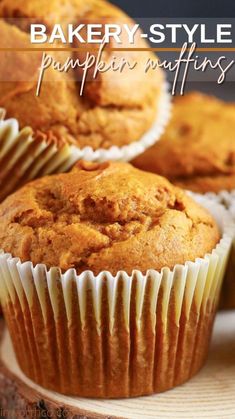 some muffins are sitting on top of a wooden board with the words, bakery style pumpkin muffins