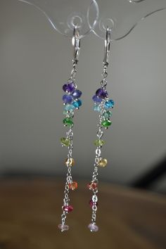 "These Long Ombre Rainbow Cluster Earrings present gemstones in a minimal and timeless way. The gemstones display the colors of the rainbow (and them some) as they descend. These Earrings are a perfect addition to your everyday attire and suitable for all special occasions, from weddings to special events. Each gemstone displays a lot of beauty and energy. Though these earrings are designed to be minimalist, their color is still impactful and they are sure to brighten your day! >Rainbow, Rain Modern Handmade Rainbow Jewelry, Modern Rainbow Jewelry For Gifts, Modern Rainbow Jewelry For Gift, Modern Rainbow Colored Jewelry For Gifts, Modern Rainbow Jewelry Gift, Fine Jewelry Gemstone Linear Earrings As Gift, Fine Jewelry Linear Gemstone Earrings, Rainbow Hypoallergenic Dangle Jewelry, Hypoallergenic Rainbow Dangle Jewelry