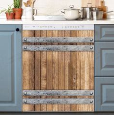 a kitchen with blue cabinets and white counter tops, wooden paneling on the wall