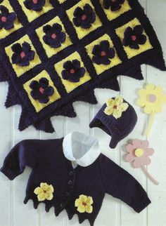 a crocheted sweater and hat with flowers on it