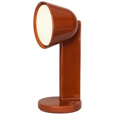 a brown table lamp with a white light on it's side and an orange base