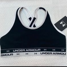 the under armour sports bra is black and white with an under armour logo on it