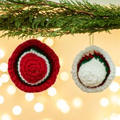 two crocheted ornaments hanging from a christmas tree