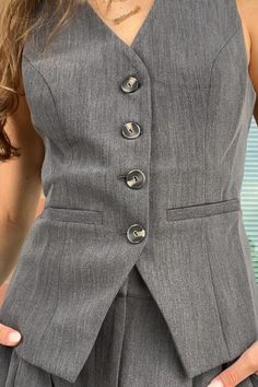 Experience the perfect match to the Denali Pant with our Celina Vest, expertly crafted from soft suiting. Featuring a v-neck, novelty buttons, and a tailored fit, this versatile piece pairs seamlessly with the Denali trousers or your favorite denim. Pair it with the Denali Pant! Fitted Gray Suit For Spring, Casual Office Suits With Button Closure, Fitted V-neck Suits For Work, Casual Suits With Button Closure For Office, Spring Gray Workwear Suits, Spring Gray Suit For Work, Classic Workwear Pants With Buttons, Classic Pants With Buttons For Workwear, Spring Gray Suits For Workwear