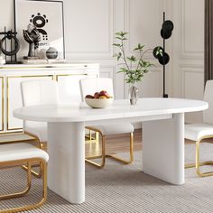 a dining room table with white chairs and a bowl of fruit on the plate next to it