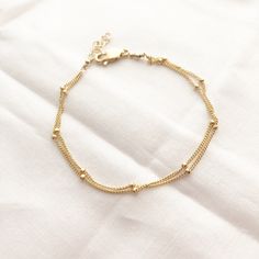 A perfect everyday dainty satellite bracelet.You can choose from 2-3 strands on a single bracelet. wear it by itself, or stack it with others. It makes the PERFECT gift for yourself or someone awesome! Wear your jewelry all day and night, even when washing your hands! We recommend cleaning your pieces once a week to keep them in great condition. Item Details:• This listing is for ONE(1) Layered satellite bracelet.• This bracelet comes with an adjustable extender for that perfect fit.• Length is Gift For Self, Jewelry Closet, Gold Bracelet Simple, Single Bracelet, Modern Gold Jewelry, Diamond Necklace Designs, Wrist Jewelry, Gold Jewelry Stores, Gold Jewelry Simple