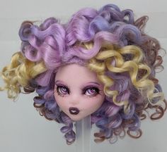 a doll with purple and yellow curly hair