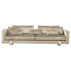 an image of a couch with pillows on the top and bottom part, in beige color