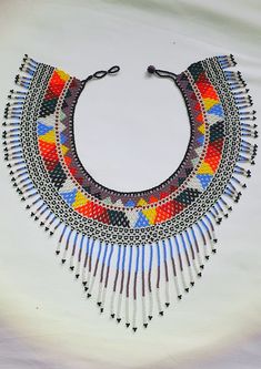 Special Native Indigenous necklace made with mustard with geometric patterns, 2 different adjustments. Rainbow bib necklace seed beads ethnic jewelry fashion, eyeglasses retainer. * It is an item in stock ready to take home. * Round Neck Size 17.5 inc (44cm) * Weight 71gr * Width 3 inch ( 7.5cm) All products are made with high-quality glass beads, strong thread high durability. Craftsmanship is the popular ancestral art of a people, a region, a country. They represent history, customs, culture, Indigenous Necklace, Ancestral Art, Necklace Seed Beads, Beaded Stuff, Eagle Design, Fashion Eyeglasses, Native American Beading, Drawings Simple, Bead Patterns