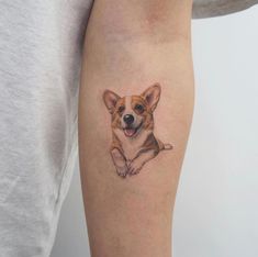 a small dog tattoo on the left arm