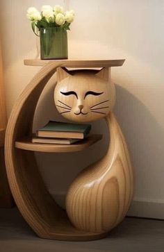 a wooden cat shelf with flowers and books on it's head, next to a lamp