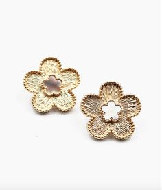 Post Back Closure Textured Gold Metal Flower with Mother of Pearl Center Light up your look with these stunning studs! These earrings feature a textured gold metal flower with a mother of pearl center, giving you a fun and unique way to add some sparkle to any outfit. Whether you're dressing up for a night out or just looking to make a statement, these clover stud earrings are sure to give you the perfect touch of whimsy and fun! 0.75W" x 0.75H" Trendy Gold Flower Charm Earrings, Chic Metal Flower Earrings For Spring, Trendy Gold Flower Earrings, Spring Gold Metal Flower Earrings, Spring Gold Flower Earrings, Gold Flower Earrings For Spring, Gold Earrings With 3d Flowers For Spring, Scarf Coverup, Rebecca Black