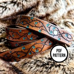 a brown leather belt with blue flowers on it and the words pdd pattern below