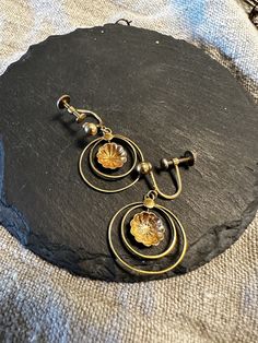 "10k Screw back vintage double hoops with a shell in the center.  Condition I see no problems-photos show the details.  Size  1 3/16\" by 3/4', wt.- 3.1 grams, nice movement and classic ." Envelope Stamp, Screw Back Earrings, 10k Gold, Rum, Screw, Selling On Etsy, Sell On Etsy, Shells, Jewelry Earrings