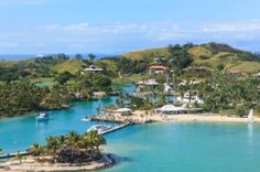 an island surrounded by water and palm trees