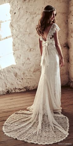 a woman in a white dress standing on a wooden floor with her back to the camera