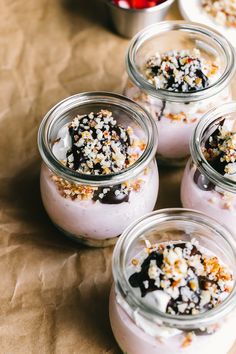 four jars filled with food sitting on top of a table