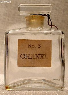 a small glass bottle with a label on the top that says no 5 chanel