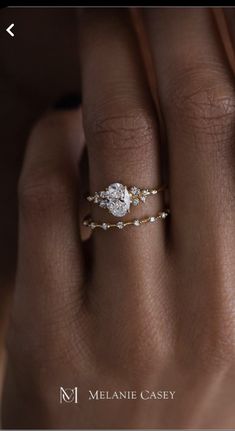 a woman's hand with a diamond ring on it