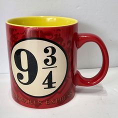 a red and yellow coffee mug with the number nine on it's front side