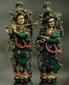 two colorfully decorated statues sitting next to each other