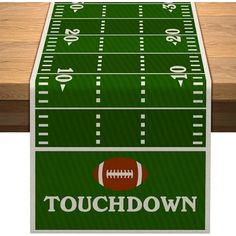 a football field table runner with the words touchdown on it and an image of a football