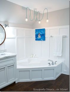 a large white bath tub sitting next to a bathroom sink