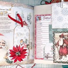 an open christmas book with santa claus and other items on it, including a red poinsetti