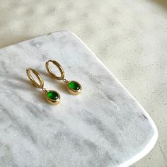 Dainty Created Emerald Gemstone Dangle Hoop Earrings Titanium 18K Gold Filled Earrings Hypoallergenic. Delicate and simple, fitting everyday wear. Stone Height: 8 mm  Stone Width: 3.5 mm Hoop inner diameter: 11 mm PRODUCT DETAIL ✧ Sold as pairs ✧ ✧ Titanium base with 18K Gold fill ✧ ✧ Nickel free Hypoallergenic and Waterproof✧ ✧ Handcrafted by our in-house jeweller✧ ✧ All packages shipped from Toronto ✧ ✧ Gift-ready packages with each order ✧ Hey! Before placing your order, why not check out oth Green Teardrop Hoop Earrings For Everyday, Everyday Green Teardrop Hoop Earrings, Minimalist Green Hoop Huggie Earrings, Green Minimalist Small Hoop Huggie Earrings, Green Minimalist Huggie Hoop Earrings, Small Hoop Earrings For May Birthstone, Green Small Hoop Earrings Tarnish Resistant, Small Hoop Green Earrings Tarnish Resistant, Small Hoop Green Tarnish-resistant Earrings