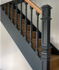 an image of a stair case with wood handrails