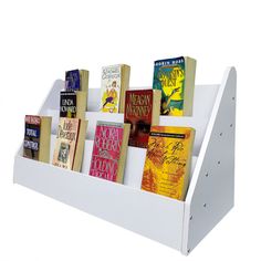 a white book rack with several books on it