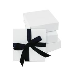 three white boxes with black ribbon tied around the top one box has a bow on it