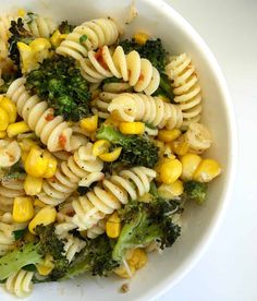 a white bowl filled with pasta and broccoli