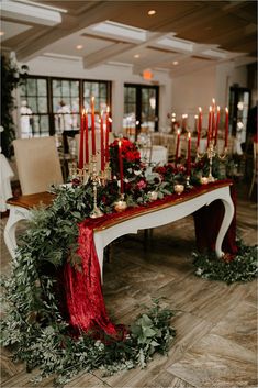 the table is set with candles and greenery for an elegant christmas dinner or reception