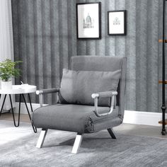 a gray chair sitting on top of a carpeted floor