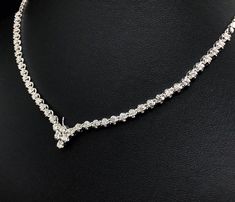 She'll never tire of wearing this classic and sophisticated diamond tennis necklace. Stunning in 18K solid white gold, this breathtaking line of shimmering round diamonds. So elegant, this 18.0-inch diamond necklace will take her breath away. Radiant with 3.08 cts. t.w. of diamonds and buffed to a brilliant luster, this glamorous keepsake secures with a box clasp. The setting design make the diamonds look much bigger than they are. When worn, the diamonds look like 1/5 carat each. Diamonds Detai Classic Platinum Tennis Necklace With Single Cut Diamonds, Luxury Diamond Necklace With Tension Setting For Formal Events, Luxury Diamond Necklace With Tension Setting For Formal Occasions, Wedding Tennis Necklace In Platinum With Single Cut Diamonds, Vvs Clarity White Gold Tennis Necklace For Wedding, Timeless Diamond Cut Tennis Necklace For Wedding, White Gold Tennis Necklace With Vvs Clarity For Wedding, Wedding Platinum Tennis Necklace With Single Cut Diamonds, Platinum Tennis Necklace With Single Cut Diamonds For Wedding