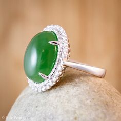 A stunning translucent large oval green nephrite jade ring. The jade is set in a double diamond halo setting in solid 18KT white gold. The jade is about 12x16mm and is approx. 11.45 carats. The total weight of the brilliant cut round white diamonds is 0.46 carats. The band is 2 - 3mm. This is a significant size ring! This ring would make a statement and is a lovely cocktail ring or engagement ring. Dimensions: Natural untreated AAA gem grade Nephrite Jade: 11.45 carats Origin - Siberia Color: Br Oval Jade Ring For Wedding, Oval Jade Wedding Ring, 35th Wedding Anniversary, Alternative Bridal, Double Diamond, Nephrite Jade, Halo Setting, Jade Ring, Jade Carving