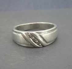 a silver ring sitting on top of a table