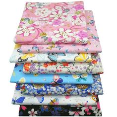 a stack of different colored fabrics on top of each other in various sizes and colors