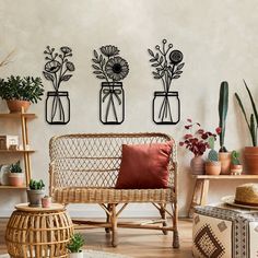 three vases with flowers are on the wall above a wicker chair