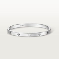 Cartier - LOVE bracelet, medium model - Bracelet Woman  - LOVE bracelet, medium model, 18K white gold (750/1000), closure system with functional screw and hinge. Comes with a screwdriver. Width 4.8mm. Created in New York in 1969, the LOVE bracelet is a jewelry design icon: a close fitting, oval bracelet composed of two rigid arcs, which is worn on the wrist and removed using a special screwdriver. Cartier continues the story of the original LOVE bracelet with a version featuring a hinge and an intermediate width, between the small and classic models. Same design, same story: a timeless – yet slightly slimmer – creation which is fastened using a screwdriver. On this model, the closing system consists of a functional screw on one side of the bracelet and a hinge on the other, enabling it to Oval Bracelet, Design Icon, Love Bracelet, Bracelet Collection, Cartier Love Bracelet, Love Bracelets, Screwdriver, Womens Bracelets, Cartier