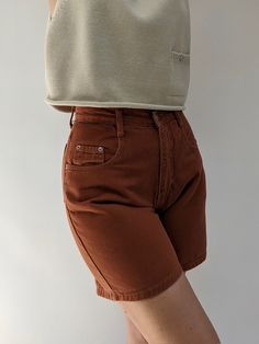 Vintage high rise denim short in a beautiful burnt sienna colored denim fabric. Sweet paired with our Milo Pima Cotton Vest. Tag reads Forelli Denim / Made in USA If you would like additional info or images prior to final sale purchase please reach out to vintage@naninstudio.com. Vintage items may come with minor flaws due to pre loved wear. Color of product may slightly vary compared to photo due to lighting. Please enjoy and appreciate this item with its character. Vintage items are FINAL SALE Cotton Jean Shorts With Pockets, Brown Cotton Shorts For Fall, Trendy Brown Shorts, Jean Shorts With Pockets For Fall, Fall Jean Shorts With Pockets, Brown Shorts With Pockets For Fall, Fall Season Jean Shorts With Pockets, High Waist Brown Shorts For Fall, High Waist Cotton Shorts For Fall