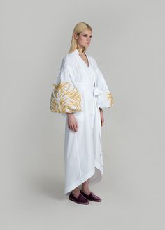 Luxurious White/Gold Kolossya Women's Midi Caftan Yuliya Magdych Spring Cotton Kaftan With Floral Embroidery, Spring Cotton Kaftan With Geometric Embroidery, Elegant Cotton Kaftan For Spring, White Cotton Kimono With Floral Embroidery, White Long-sleeve Kaftan With Woven Motifs, Elegant Cotton Kaftan For The Beach, Elegant Cotton Dress With Geometric Embroidery, Elegant Summer Cotton Kaftan, White Long Sleeve Kaftan With Woven Motifs