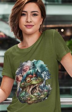 This Magical Mountain House T-Shirt exudes a sense of adventure and wonder, perfect for nature lovers and outdoor enthusiasts. The soft and lightweight fabric makes it ideal for year-round wear. The classic fit and versatile style make it suitable for any occasion, whether it's a casual day out or a hiking trip in the mountains. A great choice for those who appreciate the beauty of the outdoors.

Product features
- Soft and durable ring-spun cotton fabric
- Classic crew neckline and clean design
- Ethically sourced and sustainably made in the US
- Comfortable fit with tear-away label
- Variety of fabric blends for different color options

Care instructions
- Do not dryclean
- Machine wash: warm (max 40C or 105F)
- Do not bleach
- Tumble dry: low heat
- Iron, steam or dry: low heat Green Crew Neck T-shirt For Outdoor, Green Crew Neck T-shirt For Outdoor Activities, Green Crew Neck Top For Outdoor, Green Short Sleeve T-shirt For Outdoor, Green Graphic Tee For Outdoor, Green Graphic Print T-shirt For Outdoor, Green Graphic Print Outdoor T-shirt, Outdoor Green T-shirt With Graphic Print, Green Short Sleeve Tops For Outdoor